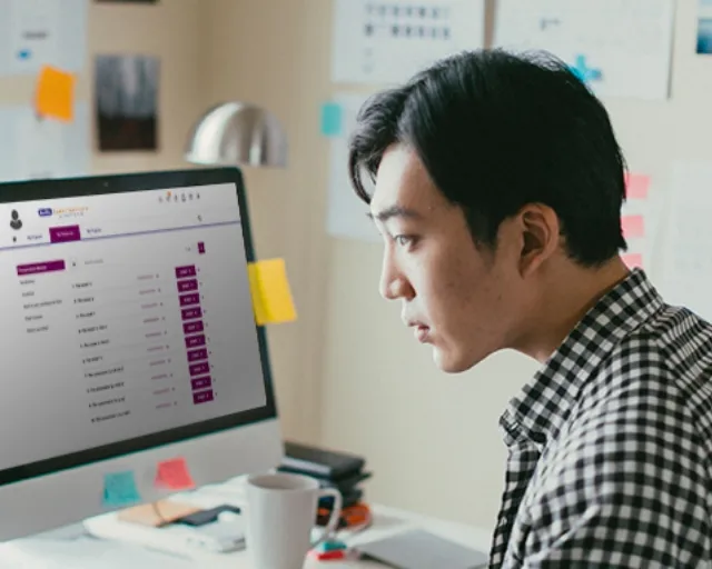 Man attending an english group class online through the Berlitz CyberTeachers platform at home.