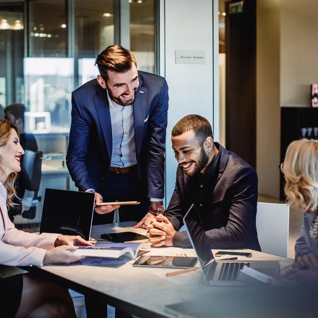 Diverse professionals engaged in a collaborative meeting during a corporate culture training session