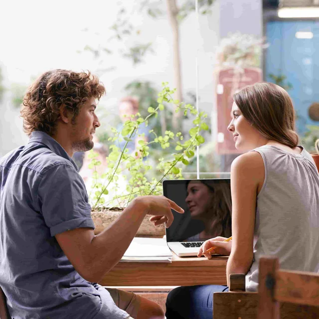 Two students practicing conversation in a relaxed setting, showcasing Berlitz english classes online focus on real-world communication skills.