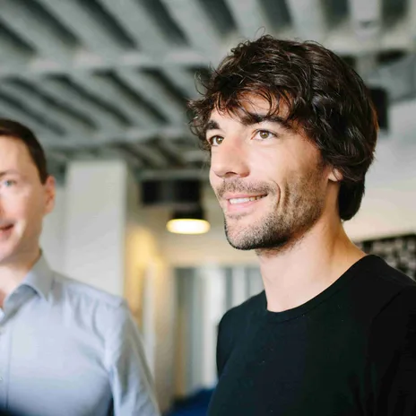Group of professionals having a casual discussion in a modern office environment.