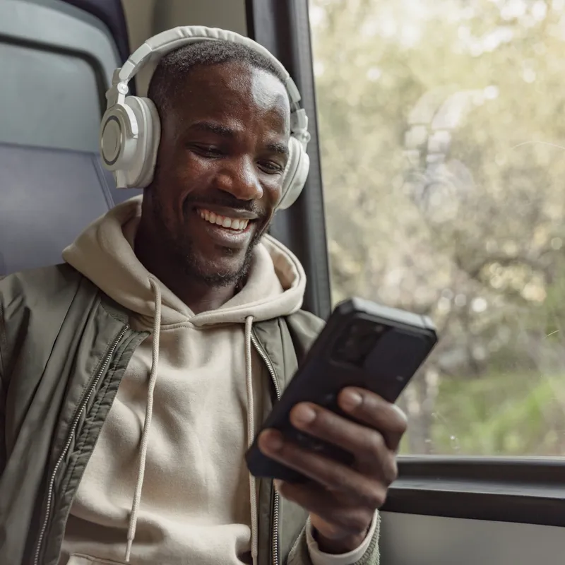 Man on train working on his phone